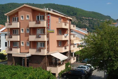 a building with cars parked in front of it at Hotel Fineso in Budva