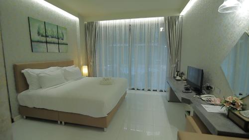 Ένα ή περισσότερα κρεβάτια σε δωμάτιο στο Namthong Nan Hotel