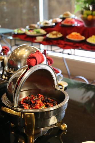 a pot with food in it on a table at Aryaduta Pekanbaru in Pekanbaru