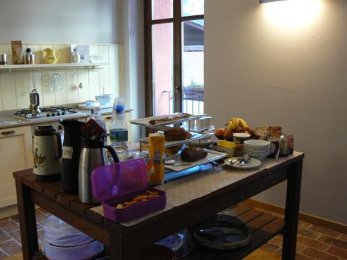 a kitchen with a table with food on it at B&B La Ceramica Moline in Vicoforte