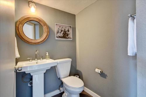 a bathroom with a toilet and a sink and a mirror at Littlefield Lofts #701 in Austin