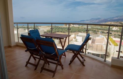 a balcony with a table and chairs and a view at Lagada Resort in Makry Gialos