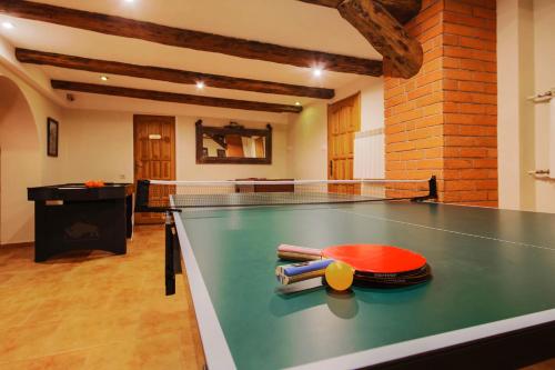 a ping pong table in the middle of a room at Willa Wincentówka w sercu Uzdrowiska in Szczawnica