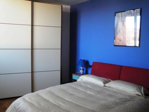 a bedroom with a bed and a blue wall at cozy private room in Florence