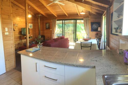 eine Küche und ein Wohnzimmer mit einer großen Arbeitsplatte in der Unterkunft Sandpiper Ocean Cottages in Bicheno