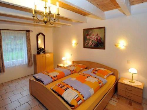 a bedroom with a bed with orange and white pillows at Hackerhof-Westwohnung in Morsum