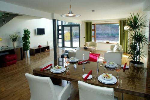 a dining room and living room with a table and chairs at Castlemartyr Holiday Lodges 3 Bed by Trident Holiday Homes in Castlemartyr