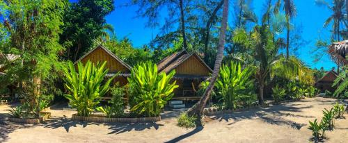 a resort on the beach with palm trees at Forra Dive Resort Sunrise in Ko Lipe