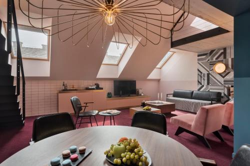 a room with a table with a bowl of fruit on it at Stories Boutique Hotel in Budapest