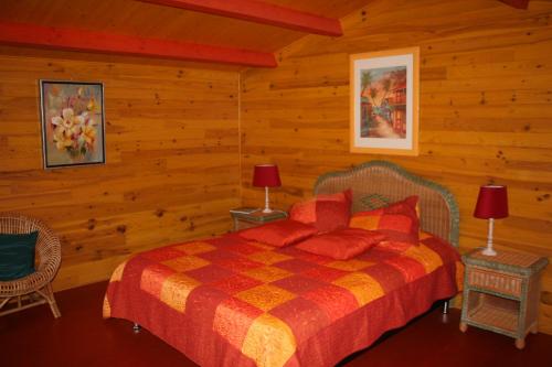 a bedroom with a bed in a log cabin at Chalet aux pied des vignes in Montigny
