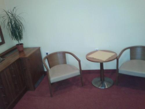a room with two chairs and a table and a stool at Parkhotel Centrum in Spišská Nová Ves