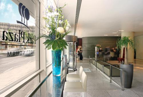 a blue vase with white flowers in a lobby at Park Plaza Nottingham in Nottingham