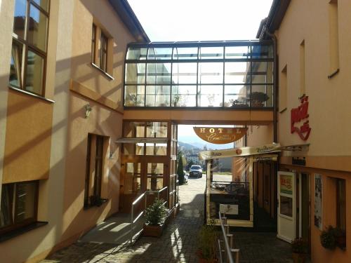 a building with a walkway in the middle of a street at Parkhotel Centrum in Spišská Nová Ves