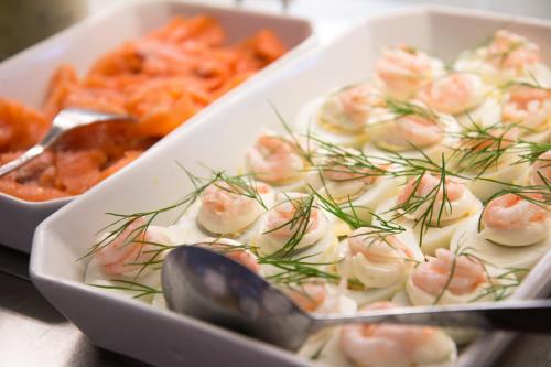 a tray of food with shrimp and dill on it at Hotell Conrad in Karlskrona