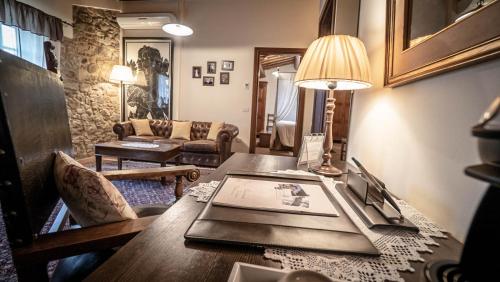 a living room with a table with a laptop on it at B&B Hotel La Piana in Borgo a Buggiano