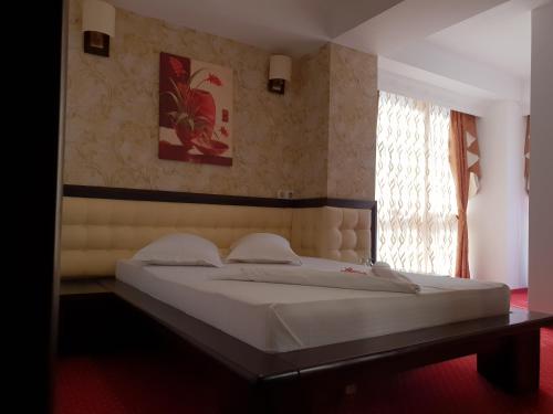 Ένα ή περισσότερα κρεβάτια σε δωμάτιο στο Pensiunea Ghiocela