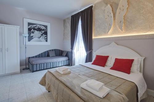 a bedroom with a large bed with red pillows at Leone X Guest House in Florence