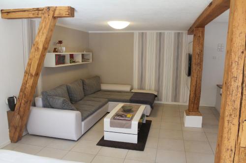 a living room with a couch and a coffee table at Ferienwohnung-Dorothe in Rheinau