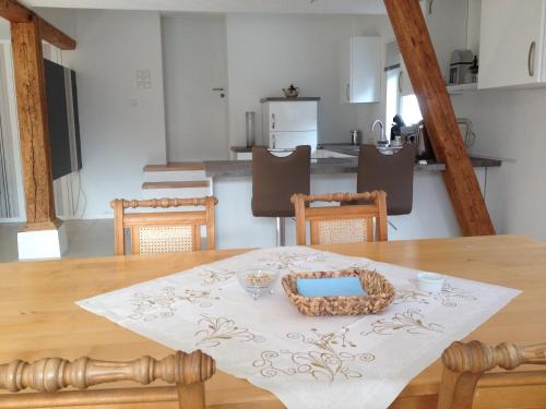 a table with a basket on top of it in a kitchen at Ferienwohnung-Dorothe in Rheinau