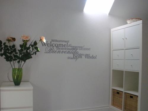 a room with a vase of flowers on a wall at Ferienwohnung-Dorothe in Rheinau