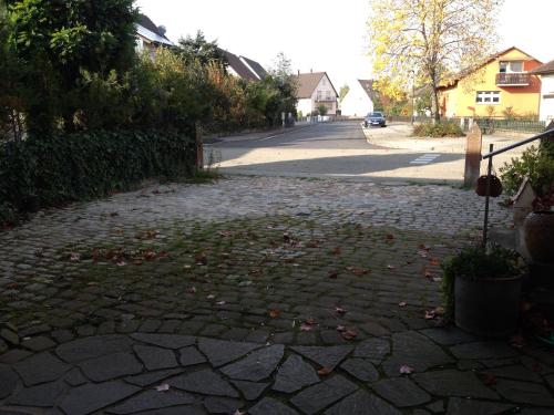 a cobblestone street with leaves on the ground at Ferienwohnung-Dorothe in Rheinau