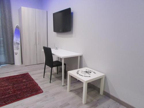 a room with a table and a chair and a tv at B&B da Lillo in Frosinone