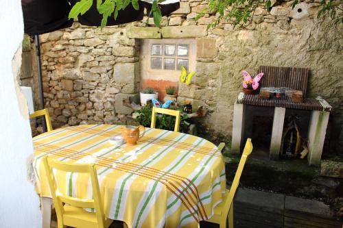 d'une table, de chaises et d'une cheminée. dans l'établissement Maison près Cité de Carcassonne, à Villalier