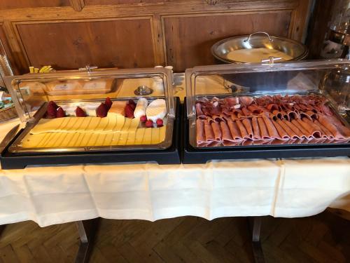 two trays of hot dogs and other meats on a table at Schmied von Kochel in Kochel