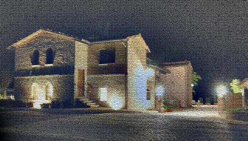 a painting of a brick house with lights at Colleverde Country House & SPA Urbino in Urbino