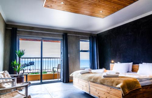 a bedroom with a bed with a view of the ocean at Hotel A la Mer in Swakopmund