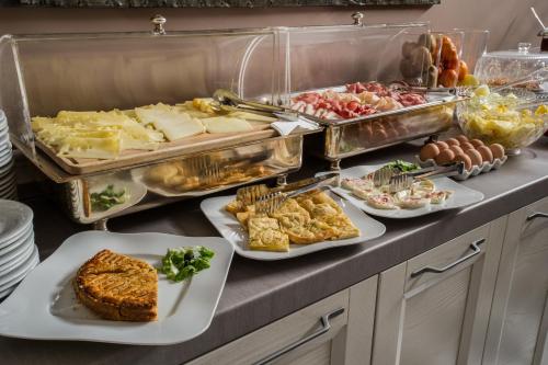 a buffet with many plates of food on a counter at Hotel Residenza In Farnese in Rome