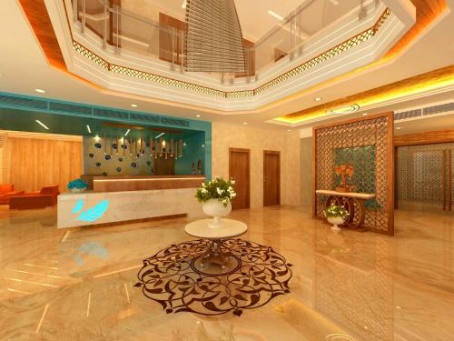 a lobby with a table in the middle of a room at SKK Blu Hotel & Spa in Udaipur