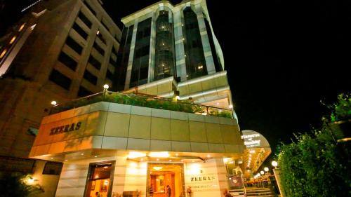 a building at night with a large building at Hotel Zeeras in Varanasi