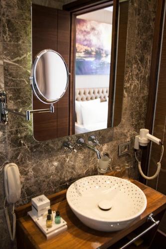 a bathroom with a sink and a mirror at Old Port Hotel in Istanbul