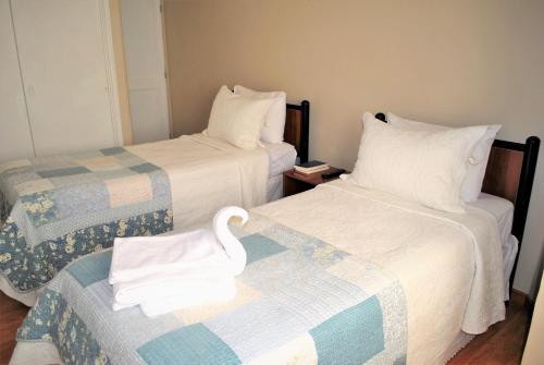 Ένα ή περισσότερα κρεβάτια σε δωμάτιο στο Hostal Pehuenche