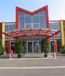a large red structure in front of a building at Motel Pelikan in Dettelbach