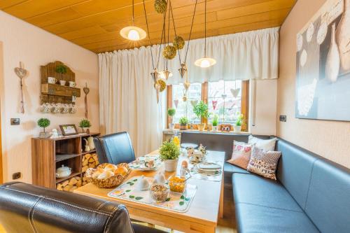 a living room with a table and a blue couch at Privatzimmer Ulbricht/Föhr in Friedrichshafen