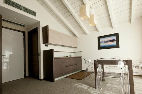 a kitchen with a table and chairs in a room at Locanda Sant'Ambrogio in Rivalta