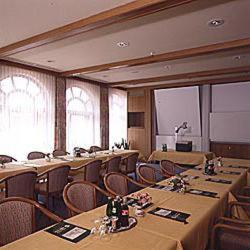 a large room with tables and chairs with bottles on them at Häffner Bräu in Bad Rappenau