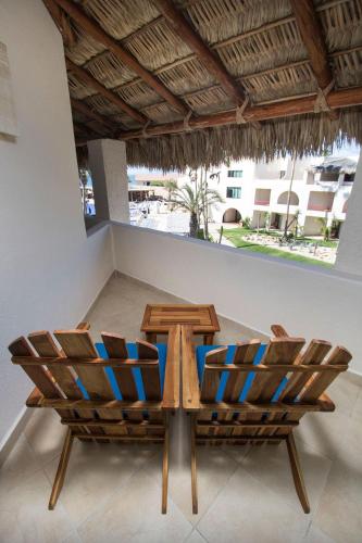 two chairs and a table in a room at Grand Decameron Los Cabos, A Trademark All-Inclusive Resort in San José del Cabo