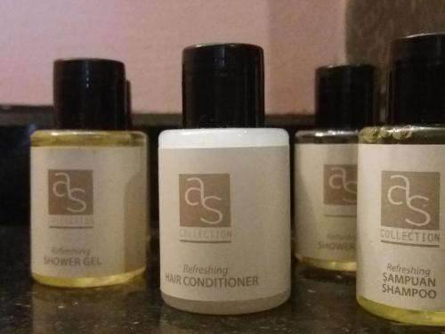 a group of five bottles of moisturizers sitting on a counter at Sakura Hostel Fethiye in Fethiye