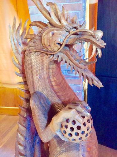 a statue of a dragon holding a ball at Locanda Vesuna Hotel Countryhouse in Pienza