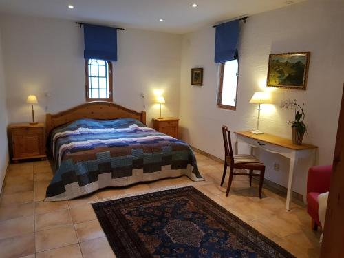 a bedroom with a bed and a table and a desk at Linda Gård apartment in Yngsjö