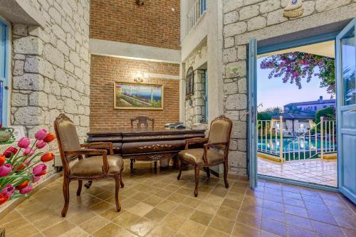 a living room with a table and chairs at Villa Fora Hotel in Alacati