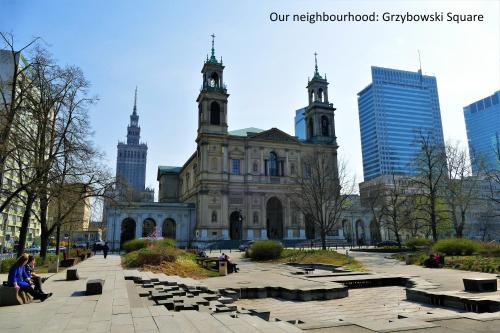 an old building with a clock tower in a city at Warsaw Hostel Centrum Private Rooms & Dorms in Warsaw