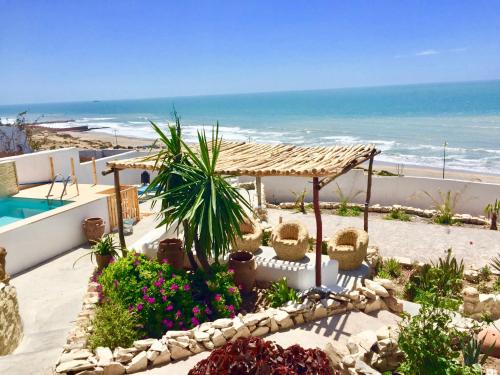 a resort with a swimming pool and the beach at Villa Jardin De l'Ocean in Aourir