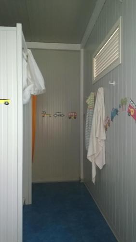 a bathroom with a shower and a blue floor at Macarìa Agricampeggio in Alliste