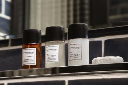 three bottles of essential oils sitting on a shelf at Praktik Bakery in Barcelona