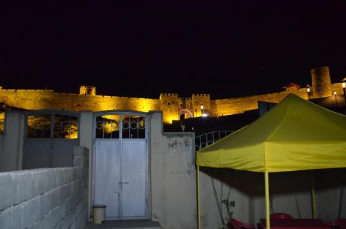 a tent in front of a castle at night at Light House Old City in Akhaltsikhe
