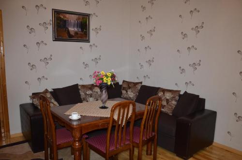 a living room with a table and a couch at Light House Old City in Akhaltsikhe